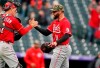 Cincinnati Reds catcher Tyler Stephenson, left, congratulates relief pitcher Tejay Antone after Antone got Colorado Rockies' Garrett Hampson to ground into a double play to end the ninth inning of a baseball game Sunday, May 16, 2021, in Denver. (AP Photo/David Zalubowski)