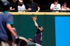 Cleveland Indians left fielder Eddie Rosario snags a fly ball deep into the corner for an out in the first inning of a baseball game Sunday, May 16, 2021, in Seattle. (AP Photo/Elaine Thompson)