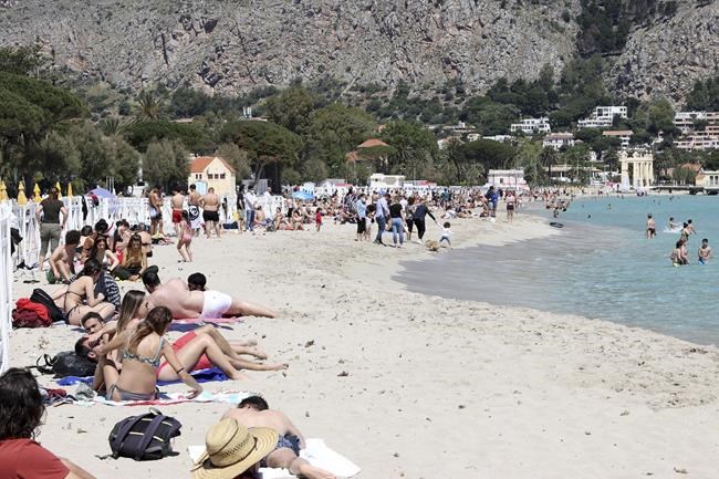 A view of the beach of Mondello, Sicily, crowded with sunbathers after the slowdown of the diffusion of Covid-19 virus allowed the reopening of beaches in Sicily. (Alberto Lo Bianco/LaPresse via AP)