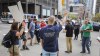 Supporters of Pastor Tim Stephens sing hymns and pray outside the Calgary Courts Centre in Calgary, Alta., on Monday, May 17, 2021. Stephens was arrested Sunday for organizing a church service that police say did not comply with public health orders on masking, physical distancing and attendance limits. THE CANADIAN PRESS/Jeff McIntosh