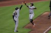 San Francisco Giants' Mauricio Dubon, right, high-fives Ron Wotus (23) after hitting a solo home run during the sixth inning of a baseball game against the Cincinnati Reds in Cincinnati, Monday, May 17, 2021. (AP Photo/Aaron Doster)