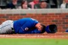 New York Mets' Kevin Pillar lies on the ground after being hit in the face with a pitch from Atlanta Braves pitcher Jacob Webb in the seventh inning of a baseball game Monday, May 17, 2021, in Atlanta. (AP Photo/John Bazemore)