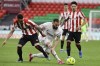 Real Madrid's Karim Benzema, center, duels for the ball with Athletic Bilbao's Alex Berenguer during Spanish La Liga soccer match between Athletic Bilbao and Real Madrid at San Mames stadium, in Bilbao, northern Spain, Sunday, May 16, 2021. (AP Photo/Alvaro Barrientos)