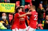 Manchester United's Edinson Cavani, left, celebrates scoring the opening goal with Manchester United's Paul Pogba, center, and Manchester United's Luke Shaw during the English Premier League soccer match between Manchester United and Fulham at Old Trafford stadium in Manchester, England, Tuesday, May 18, 2021. (AP Photo/Phil Noble, Pool)