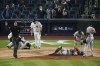 Players gather around New York Yankees' Rougned Odor (18) and Houston Astros catcher Martin Maldonado after they were injured during the sixth inning of a baseball game Tuesday, May 4, 2021, in New York. (AP Photo/Frank Franklin II)