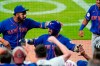 New York Mets' Tomas Nido (3) is greeted at the dugout by Jonathan Villar (1) after hitting a solo home run during the ninth inning of the team's baseball game against the Atlanta Braves on Tuesday, May 18, 2021, in Atlanta. (AP Photo/John Bazemore)