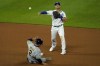 Kansas City Royals second baseman Whit Merrifield throws to first for the double play hit into by Milwaukee Brewers' Pablo Reyes after forcing Luis Urias (2) out at second during the sixth inning of a baseball game Tuesday, May 18, 2021, in Kansas City, Mo. (AP Photo/Charlie Riedel)