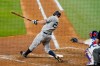 New York Yankees second baseman DJ LeMahieu follows through on a two-run double as Texas Rangers catcher Jonah Heim looks on in the fourth inning of a baseball game in Arlington, Texas, Tuesday, May 18, 2021. (AP Photo/Tony Gutierrez)
