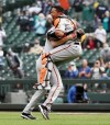 Baltimore Orioles pitcher John Means, left, and catcher Pedro Severino celebrate after Means threw a no-hitter against the Seattle Mariners in a baseball game Wednesday, May 5, 2021, in Seattle. (Ken Lambert/The Seattle Times via AP)