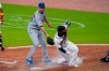 Atlanta Braves' Guillermo Heredia (38) beats the tag from New York Mets starting pitcher David Peterson (23) to score on a wild pitch during the fifth inning of a baseball game Wednesday, May 19, 2021, in Atlanta. (AP Photo/John Bazemore)