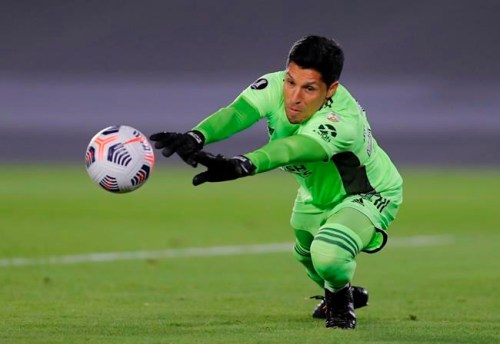 Goalkeeper Enzo Nicolas Perez of Argentina's River Plate stops a ball during a Copa Libertadores soccer match against Colombia's Independiente Santa Fein Buenos Aires, Argentina, Wednesday, May 19, 2021. (Juan Ignacio Roncoroni/Pool via AP)