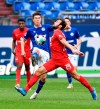 Schalke's Matthew Hoppe, left, controls the ball as Berlin's Lucas Tousart (29) closes in during the German Bundesliga soccer match between Hertha BSC Berlin and FC Schalke 04 in Gelsenkirchen, Germany, Wednesday, May 12, 2021. (AP Photo/Martin Meissner, Pool)