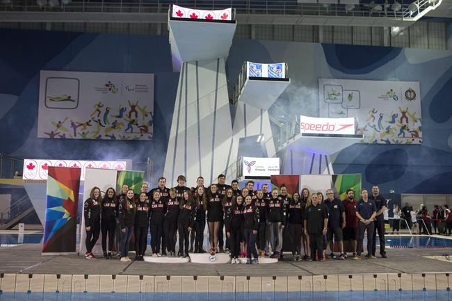 Canada's new Olympic swim team poses for a group photo following a ceremony in Toronto, on Sunday, April 10, 2016. THE CANADIAN PRESS/Chris Young