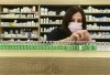 Pharmacist Barbara Violo arranges all the empty vials of the Oxford-AstraZeneca COVID-19 vaccines at the Junction Chemist during the COVID-19 pandemic in Toronto, on Monday, April 19, 2021. THE CANADIAN PRESS/Nathan Denette