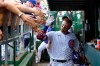 Chicago Cubs' Ian Happ, seen through COVID-19 protective plexiglass, celebrate his two-run homer off Washington Nationals starting pitcher Joe Ross with teammates in the dugout during the third inning of a baseball game Thursday, May 20, 2021, in Chicago. (AP Photo/Charles Rex Arbogast)