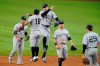 New York Yankees' Rougned Odor (18) and Aaron Judge, center right, leap as they celebrate with others following their team's 2-0 win in a baseball game against the Texas Rangers in Arlington, Texas, Thursday, May 20, 2021. Gleyber Torres, left, Brett Gardner, bottom center, and Gio Urshela (29) join the celebration. (AP Photo/Tony Gutierrez)