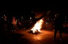 A woman jumps next to a flaming barricade during an anti-government protest in Bogota, Colombia, Thursday, May 20, 2021. Colombians have taken to the streets for weeks across the country after the government proposed tax increases on public services, fuel, wages and pensions.(AP Photo/Fernando Vergara)