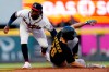 Pittsburgh Pirates' Adam Frazier (26) is tagged out at second base by Atlanta Braves second baseman Ozzie Albies on an attempted steal during the third inning of a baseball game Thursday, May 20, 2021, in Atlanta. (AP Photo/John Bazemore)
