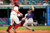 Minnesota Twins' Alex Kirilloff, right, scores as Cleveland Indians catcher Austin Hedges waits for the ball in the fourth inning of a baseball game, Friday, May 21, 2021, in Cleveland. (AP Photo/Tony Dejak)