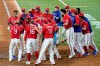 Texas Rangers' Adolis Garcia, second from left with foot on home plate, celebrates with teammates after hitting a three-run, walk-off home run in the 10th inning of the team's baseball game against the Houston Astros in Arlington, Texas, Friday, May 21, 2021. (AP Photo/Tony Gutierrez)