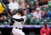 Colorado Rockies Charlie Blackmon follows the flight of his two-run home run off Arizona Diamondbacks starting pitcher Madison Bumgarner in the sixth inning of a baseball game Saturday, May 22, 2021, in Denver. (AP Photo/David Zalubowski)