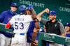Texas Rangers' Adolis Garcia (53) celebrates his second solo home run with manager Chris Woodward, front right, during the seventh inning of a baseball game against the Houston Astros, Saturday, May 22, 2021, in Arlington, Texas. (AP Photo/Michael Ainsworth)