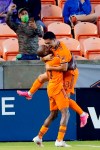 Houston Dynamo's Fafa Picault (10) and midfielder Memo Rodriguez (8) celebrate Rodriguez's goal during the first half of an MLS soccer match against the Vancouver Whitecaps, Saturday, May 22, 2021, in Houston. (AP Photo/Michael Wyke)