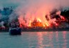 A boat with players cruises on Sava river as Red Star fans celebrate after their team won the Serbian soccer league title in Belgrade, Serbia, Saturday, May 22, 2021. (AP Photo/Darko Vojinovic)