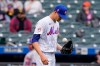 New York Mets starting pitcher Jacob deGrom tosses the ball during the fifth inning of a baseball game against the Arizona Diamondbacks, Sunday, May 9, 2021, in New York. deGrom left the game in the sixth inning after throwing only two warmup pitches. (AP Photo/Kathy Willens)