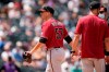 Arizona Diamondbacks starting pitcher Taylor Widener, left, heads to the dugout after he was pulled from the mound in the second inning of a baseball game against the Colorado Rockies, Sunday, May 23, 2021, in Denver. (AP Photo/David Zalubowski)