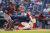 Philadelphia Phillies' Brad Miller, right, slides into home on the sacrifice fly by Andrew McCutchen with Boston Red Sox catcher Christian Vazquez, left, getting the throw during the eighth inning of a baseball game, Sunday, May 23, 2021, in Philadelphia. (AP Photo/Chris Szagola)