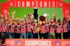 Atletico Madrid players celebrate with the trophy at the Wanda Metropolitano stadium in Madrid, Spain, Sunday, May 23, 2021. Atletico Madrid survived a dramatic final round to clinch its first Spanish league title since 2014 with a 2-1 come-from-behind win at Valladolid on Saturday. (AP Photo/Manu Fernandez)