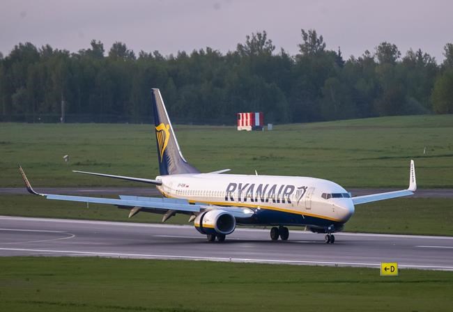 The Ryanair plane with registration number SP-RSM, carrying opposition figure Raman Pratasevich which was traveling from Athens to Vilnius and was diverted to Minsk after a bomb threat, lands at the International Airport outside Vilnius, Lithuania, Sunday, May 23, 2021. The presidential press service said President Alexander Lukashenko personally ordered that a MiG-29 fighter jet accompany the Ryanair plane carrying opposition figure Raman Pratasevich and traveling from Athens, Greece, to Vilnius, Lithuania to the airport in the capital Minsk. (AP Photo/Mindaugas Kulbis)