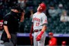 Cincinnati Reds' Tyler Stephenson reacts after he was called out on strikes on a check swing by home plate umpire Joe West while facing Colorado Rockies relief pitcher Mychal Givens during the eighth inning of a baseball game Thursday, May 13, 2021, in Denver. (AP Photo/David Zalubowski)