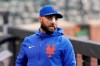 Injured New York Mets player Kevin Pillar wears a bandage on his nose in the dugout before a baseball game against the Colorado Rockies, Monday, May 24, 2021, in New York. Pillar was hit in the face by a fastball last week and underwent surgery Friday to repair nasal fractures. (AP Photo/Kathy Willens)