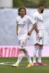 Real Madrid's Luka Modric and Karim Benzema, right, react during the Spanish La Liga last round soccer match between Real Madrid and Villarreal at the Alfredo Di Stefano stadium in Madrid, Saturday, May 22, 2021. (AP Photo/Pablo Morano)