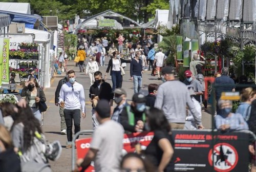 People wear face masks as they walk through the Atwater Market in Montreal, Monday, May 24, 2021, as the COVID-19 pandemic continues in Canada and around the world. THE CANADIAN PRESS/Graham Hughes