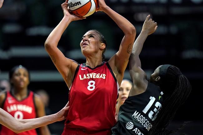 Las Vegas Aces' Liz Cambage (8) shoots over Seattle Storm's Ezi Magbegor in the first half of a WNBA basketball game Saturday, May 15, 2021, in Everett, Wash. (AP Photo/Elaine Thompson)