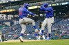 Chicago Cubs' Joc Pederson, left, celebrates with third base coach Willie Harris as he runs the bases after hitting a two-run home run off Pittsburgh Pirates starter Cody Ponce, rear, during the fifth inning of a baseball game Tuesday, May 25, 2021, in Pittsburgh. (AP Photo/Keith Srakocic)