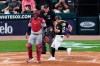 Home plate umpire Joe West watches Chicago White Sox's Adam Eaton score next to St. Louis Cardinals catcher Yadier Molina during the first inning of a baseball game Tuesday, May 25, 2021, in Chicago. (AP Photo/Charles Rex Arbogast)