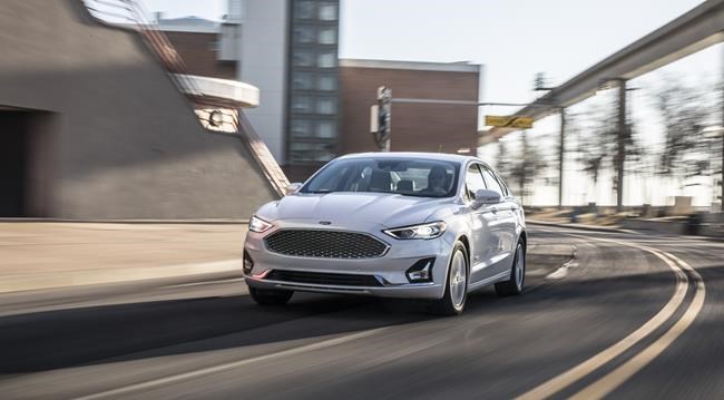 This photo provided by Ford shows a Ford Fusion Hybrid, a hybrid midsize sedan that is essentially a regular Fusion but with higher fuel economy. (Courtesy of Ford Motor Co. via AP)
