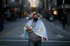 A man arrives to a protest against how the government of President Alberto Fernandez is handling the new coronavirus pandemic crisis in Buenos Aires, Argentina, Tuesday, May 25, 2021. (AP Photo/Marcos Brindicci)
