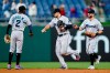 Miami Marlins' Jazz Chisholm Jr., from left, Adam Duvall and Jon Berti celebrate after the Marlins won a baseball game against the Philadelphia Phillies, Wednesday, May 19, 2021, in Philadelphia. (AP Photo/Matt Slocum)