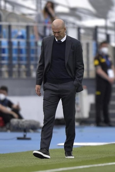 Real Madrid's head coach Zinedine Zidane walks by the touchline during the Spanish La Liga last round soccer match between Real Madrid and Villarreal at the Alfredo Di Stefano stadium in Madrid, Saturday, May 22, 2021. (AP Photo/Pablo Morano)