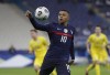 FILE - In this Wednesday, March 24, 2021 file photo, France's Kylian Mbappe controls the ball during the World Cup 2022 group D qualifying soccer match between France and Ukraine at the Start de de France stadium, in Saint Denis, north of Paris. With a chance to become the all-time top scorer with a national team, Cristiano Ronaldo will highlight the list of top players at this year's European Championship. Others who could make an impact include Kylian Mbappé, Robert Lewandowski, Kevin De Bruyne and Harry Kane. (AP Photo/Thibault Camus, File)