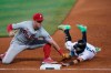 Philadelphia Phillies first baseman Rhys Hoskins, left, picks off Miami Marlins' Miguel Rojas as he dives back to first base during the eighth inning of a baseball game, Thursday, May 27, 2021, in Miami. (AP Photo/Wilfredo Lee)