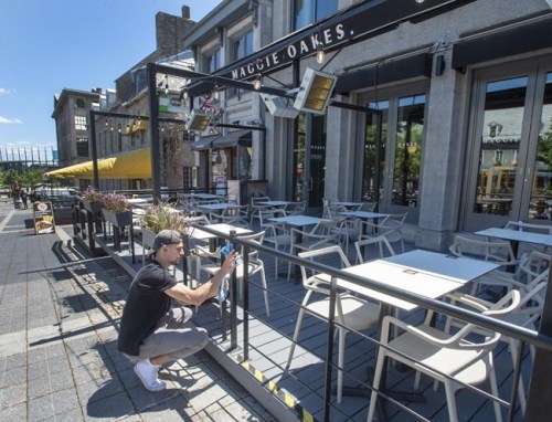 Ludovic Beaupre prepares his terrace for a re-opening on Thursday, May 27, 2021 in Montreal as Quebec begins easing its COVID-19 restrictions. Restaurant patios across the province will be permitted to reopen today. THE CANADIAN PRESS/Ryan Remiorz
