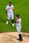 Baltimore Orioles relief pitcher Dillon Tate, right, and Baltimore Orioles third baseman Maikel Franco react after Chicago White Sox's Leury Garcia walked to first during the sixth inning of a baseball game in Chicago, Thursday, May 27, 2021. (AP Photo/Nam Y. Huh)