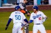 Los Angeles Dodgers' Justin Turner, right, is congratulated by Mookie Betts, left, after hitting a two-run home run as San Francisco Giants catcher Curt Casali stands at the plate during the third inning of a baseball game Thursday, May 27, 2021, in Los Angeles. (AP Photo/Mark J. Terrill)