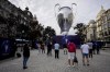 People gather next to a giant replica of the UEFA Champions League trophy in Porto, Portugal, Thursday, May 27, 2021. Manchester City will play against Chelsea in the Champions League final on Saturday. (AP Photo/Manu Fernandez)